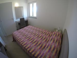 A bed or beds in a room at Appartamenti Torre