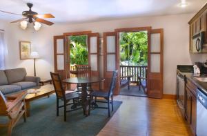 a kitchen and living room with a table and chairs at Island City House in Key West