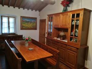 a kitchen with a wooden table and a cabinet at Villa Tacco in Quarata