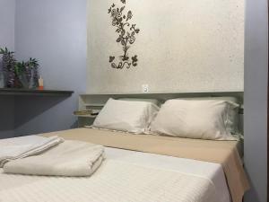 En eller flere senge i et værelse på Pousada Castelinho