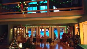 a dining room with christmas lights and a christmas tree at Two Eagles Lodge in Union Bay