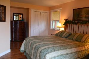 a bedroom with a large bed and a window at Two Eagles Lodge in Union Bay +25 photos