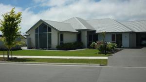 a house with a tree in front of it at Courtenay B & B in Kaiapoi +6 photos
