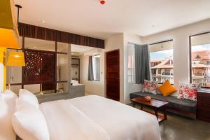 a bedroom with a large white bed and a couch at Apsara Residence Hotel in Siem Reap +37 photos