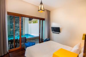 a room with a bed and a view of a pool at Apsara Residence Hotel in Siem Reap