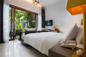 a bedroom with a large white bed and a window at Apsara Residence Hotel in Siem Reap