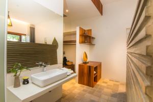 a bathroom with a white sink and a mirror at Apsara Residence Hotel in Siem Reap