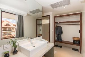 a bathroom with a white sink and a mirror at Apsara Residence Hotel in Siem Reap