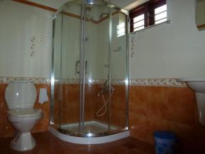 a bathroom with a shower and a toilet at Rajadhani 5th Season in Varkala