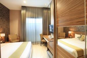 Krevet ili kreveti u jedinici u okviru objekta Rasuna Icon Hotel