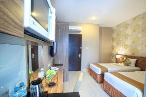 Krevet ili kreveti u jedinici u okviru objekta Rasuna Icon Hotel
