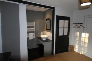 a bathroom with a sink and a mirror at La Haute Flourie - bed and breakfast -chambres d'hôtes in Saint Malo