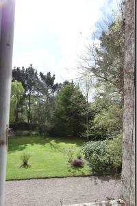 a view of a garden from a window at La Haute Flourie - bed and breakfast -chambres d'hôtes in Saint Malo