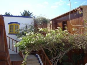 a staircase leading to a house with a yellow window at Neptune Hotel in Dahab