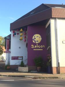 a building with a sign on the front of it at Saigon Hotel in Homburg