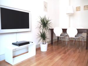 a living room with a flat screen tv on a wall at Cozy Apartment Ulmenstrasse in Lucerne