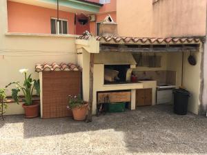 a kitchen with a counter and aesteadangering at Anna Apartment in Villaputzu +4 photos