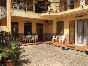 a courtyard of a house with a table and chairs at Anna Apartment in Villaputzu