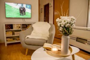 a living room with a chair and a tv at The Nook Apartment in Zagreb