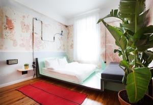 a bedroom with a bed and a potted plant at The Trilogy House in Thessaloniki