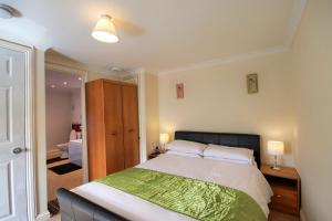 a bedroom with a large bed and a bathroom at Mount Lavinia in Sheringham
