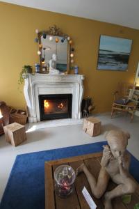 a living room with a fireplace and two people at La Haute Flourie - bed and breakfast -chambres d'hôtes in Saint Malo
