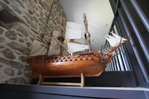 a wooden boat on display in a museum at La Haute Flourie - bed and breakfast -chambres d'hôtes in Saint Malo