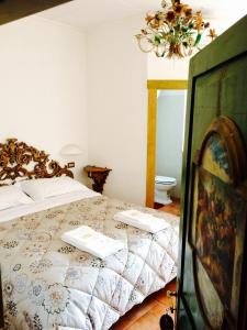 a bedroom with a bed with two books on it at La Lanterna in Avigliano
