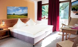 
Ein Bett oder Betten in einem Zimmer der Unterkunft Kelten-Hotel
