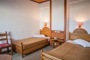 Postel nebo postele na pokoji v ubytování Hotel Galini Patmos