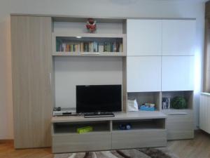 a entertainment center with a television in a living room at Casa Debora in Valdidentro