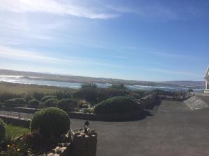 a person standing on a hill looking at the ocean at Hillcrest Holiday Home in Cruit