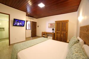 En eller flere senge i et værelse på Coconut's Maresias Hotel