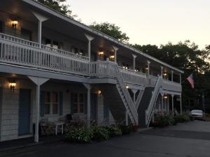 a building with a white staircase on the side of it at The Holiday House Inn & Motel in Scarborough