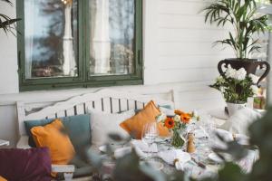 stół jadalny z pomarańczowymi i niebieskimi poduszkami w obiekcie Villa Sjötorp w mieście Ljungskile