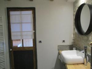 a bathroom with a sink and a mirror at la grange aux hirondelles in Sancoins