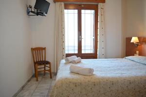 A bed or beds in a room at Anemomilos Suites