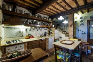 a kitchen with a stove top oven and a stove top oven at Borgo alle Mura in Casale Marittimo