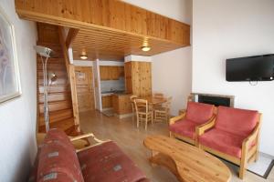 a living room with a couch and a table at Résidence Mont-Calme in Nendaz