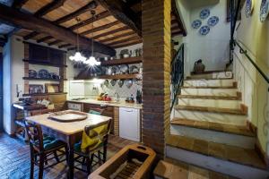 a kitchen area with a table and chairs at Borgo alle Mura in Casale Marittimo