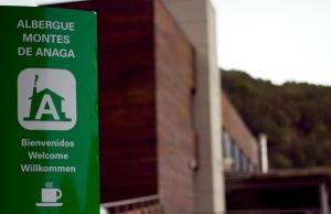 a green sign on the side of a building at Albergue Montes de Anaga in El Bailadero