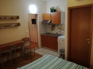 a small kitchen with a sink and a table at Apartments Kurtic in Makarska