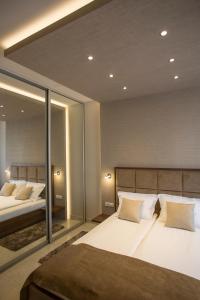 a bedroom with two beds and a large mirror at Aria Royal Nusic apartment in Belgrade