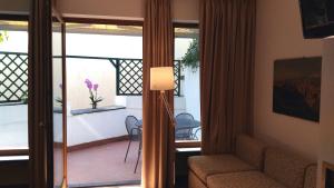 a living room with a couch and a sliding glass door at Il Pozzo in Sorrento