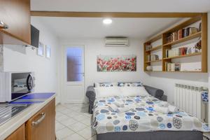 a small bedroom with a bed and a kitchen at Casa San Marcellino in Naples