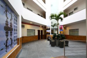 a lobby with a palm tree in a building at Casa Andina Standard Miraflores San Antonio in Lima