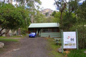a building with a car parked in front of it at Serene Vista Halls Gap in Halls Gap