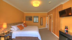 a bedroom with a white bed and a flat screen tv at Ashdowns of Dover in Dover
