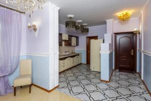 a large kitchen with purple walls and a door at Princess Elisa Hotel in Zelenogradsk