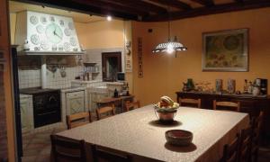 a kitchen with a table with a bowl of fruit on it at Casa Degli Amici in Treviso